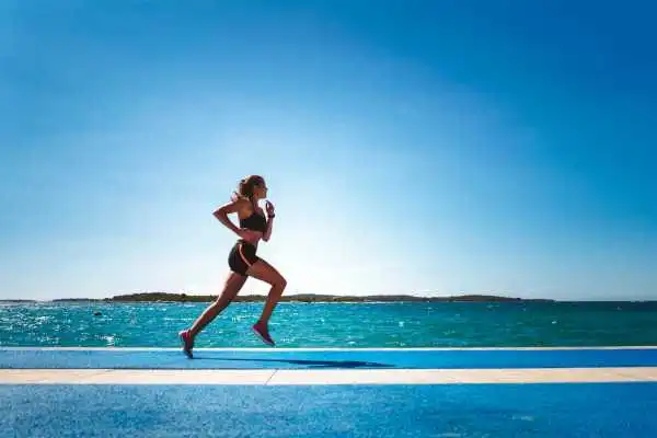 Woman running showing strong leg muscle Portsmouth